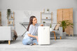 © Pixel-Shot - Modern humidifier and young woman on floor in living room