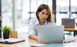 © David - asian woman work at laptop thinking of problem solution, thoughtful female employee pondering considering idea looking at computer screen making decision