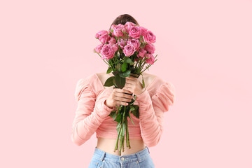 Poster - Young woman with roses on pink background