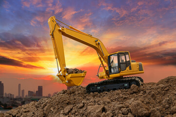 Wall Mural - Crawler Excavators with are digging the soil in the construction site on the sunset backgrounds