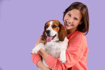 Poster - Young woman with Beagle dog on lilac background