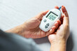 © Photo Sesaon - Woman's hands checking diabetes and hyperglycemia with digital blood sugar meter. Healthcare and medical concept