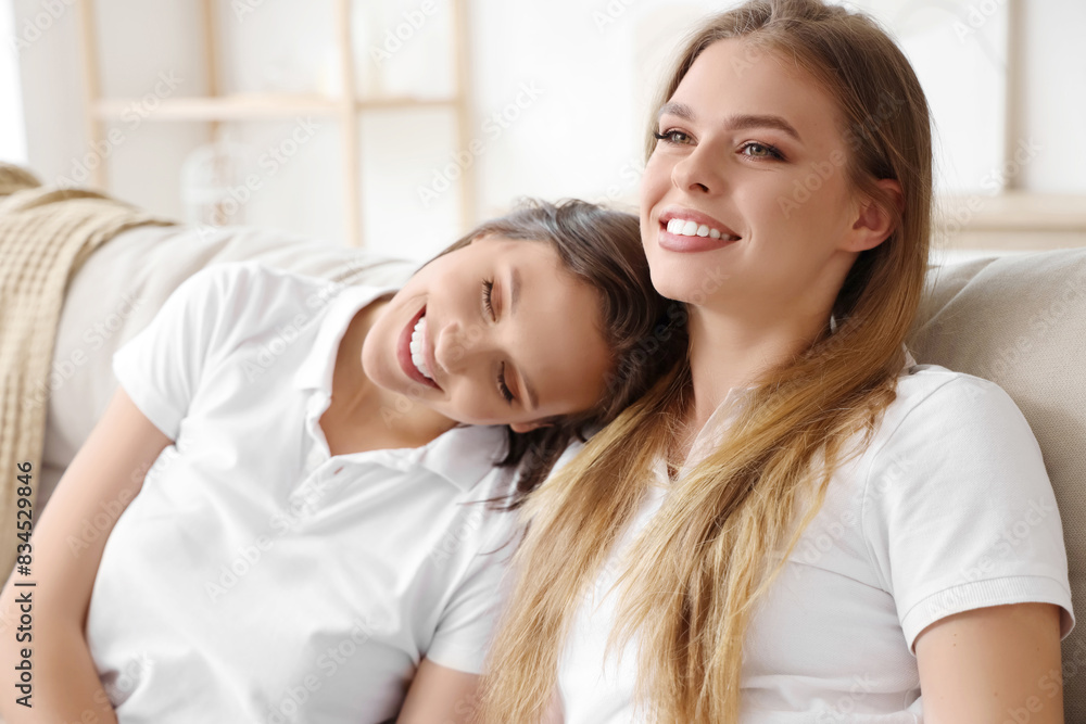 Female friends sitting on sofa at home, closeup