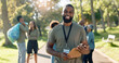 © peopleimages.com - Man, volunteer and smile portrait with clipboard in nature, checklist and environment sustainability project with group. Recycle, waste management and cleaning outside trash, help and ngo support