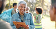 © HockleyMedia24/peopleimages.com - Park, woman and smile planning with tablet for volunteers, community project or nature sustainability. Humanitarian, recycling or senior leader in charity service or NGO for pollution cleanup