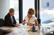 © ArcursPI/peopleimages.com - Documents, discussion and business women in office for meeting, legal consulting and agreement. Corporate lawyer, law agency and woman with client and paperwork for contract, collaboration and report