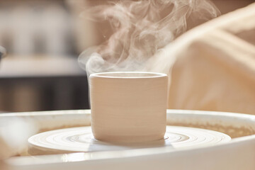 Wall Mural - Minimal background image of raw clay piece smoking on pottery wheel in art studio copy space