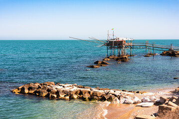 Wall Mural - Traditional wooden fishing house with a net near sea coast