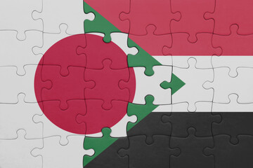 puzzle with the colourful national flag of sudan and flag of japan.