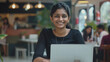 © Niks Ads - young indian female student using laptop