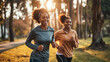 © eshana_blue - Photo of two smiling young black women friends jogging in the park in the morning, sunlight in the background.