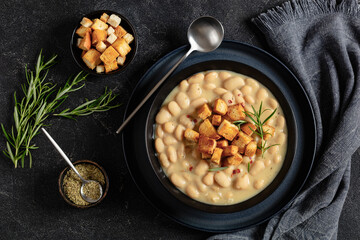 Wall Mural - rosemary garlic creamy white bean soup in bowl