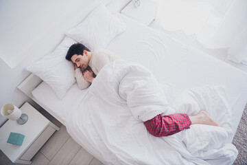 Poster - Photo of young nice man lying in soft comfy bed white bedroom interior indoors