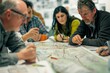 © Ilia Nesolenyi - A group of urban planners huddle around a large map, intensely studying details and discussing ideas for the citys development