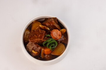 Wall Mural - Beef Afritada is a Filipino Beef Stew and Vegetables in a Tomato Sauce.