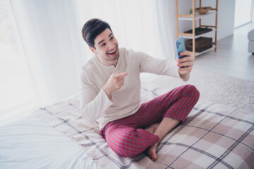 Canvas Print - Photo of positive nice man speaking live stream vlog blog morning in comfy white day light room indoors