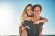 © Lyndon Stratford/peopleimages.com - Portrait, piggyback and ocean with couple, love or sunshine with happiness, honeymoon or romance. Face, seaside or man carrying woman with vacation, adventure and summer with journey, beach or smile
