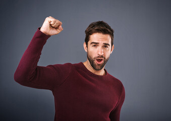 Wall Mural - Portrait, fist and man in studio with success for achievement, target or reaching goal with gray background. Cheer, scream and excited male person for celebration, victory or lotto winner on mockup