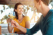 © GR/peopleimages.com - Date, wine and couple with cheers on patio for celebration, lunch and romance in happy relationship. Smile, man and woman toast with glass, drinks and outdoor dinner with love, bonding and marriage.
