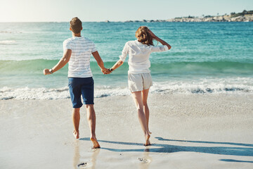 Poster - Beach, holding hands and couple with love, running and vacation for honeymoon, romance and journey. Marriage, seaside and man with woman, lens flare and adventure with support, summer and travelling