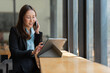 © Thitisak - Asian business woman working with tablet.