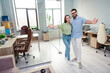 © deagreez - Photo of happy positive successful business people hold hands invite in modern office