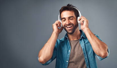 Sticker - Studio, man and headphone for music, audio media and podcast or ebook on gray background. Technology, streaming and online subscription for song, male person and smile for listening with mock up