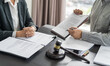 © Charlie's - Lawyer Legal counsel presents to the client a signed contract with gavel and legal law. justice and lawyer Business partnership meeting concept