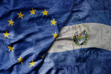 Wall Mural - big waving realistic national colorful flag of european union and national flag of el salvador on a euro money banknotes background.