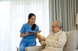 © Suney - Female health care worker is take care senior man at home.