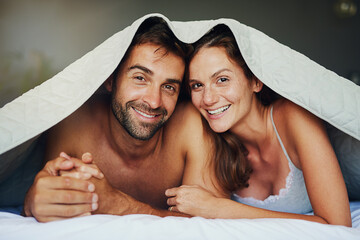 Sticker - Happy couple, portrait and relax with bed sheets for love, bonding or awake from morning together at home. Man and woman lying with smile under duvet, fabric or linen in bedroom for care or support