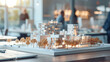 © Studio Zenith - Maquette d'un quartier, équipe de promoteurs immobiliers, d'architectes et d'hommes d'affaires travaillant sur un projet d'urbanisme