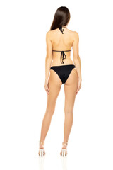 Wall Mural - Young brunette woman in bikini swimsuit posing on a white studio background. Back, rear view