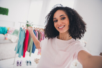 Photo of cheerful adorable lovely girl wear stylish clothes showing apartment wardrobe indoors