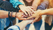 © brillianata - Close up top view of young people putting their hands together.