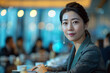 © Melvillian - Chinese businesswoman in the boardroom with blurred background.