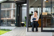 © apichat - A woman sits on a step outside a closed business