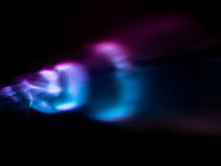 Wall Mural - light reflections in dark pink and blue for a magical abstract background.