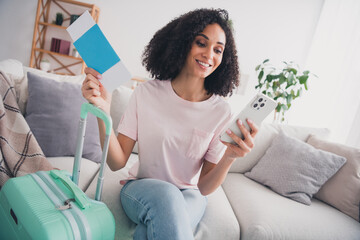 Wall Mural - Photo of lovely adorable cute girl preparing airport weekend trip resort sitting sofa indoors flat