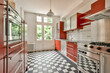 © ADDICTIVE STOCK - Modern kitchen with red cabinets and checkered floor in Rubensstraat