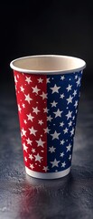 A patriotic paper cup adorned with red, white, and blue stars design, suitable for American-themed celebrations or events against a dark background.