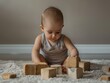© kittipoj - High-resolution photo of a baby playing with blocks, space for text below