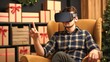 © LoLArt - Caucasian middle aged man making purchase or choosing gifts in cardboxes app using VR glasses at home as online shopping and virtual reality futuristic social media and communication