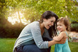 © GR/peopleimages.com - Mother, daughter and smile with playing in garden for fun activity, bonding or embrace outdoor in home. Happy family, woman or child on grass with mockup, explore or support with lens flare in nature