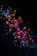 © EnricaDjango - A single brightly colored animated Molecule over a black background