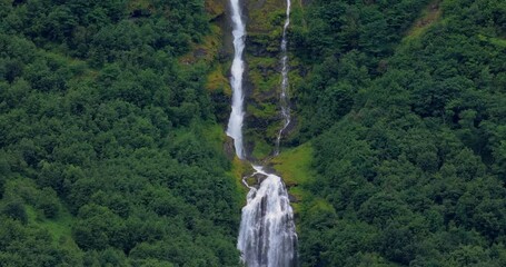 Wall Mural - Beautiful nature of Norway. A mountain waterfall from a glacier high in the mountains of Norway.