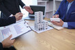 © thatinchan - group of businessmen and investors discuss investing in real estate and jointly plan investments in construction projects of condominiums and apartments for sale and rent. investment advisory concept