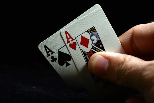 a hand holding playing cards