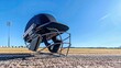 © Salman - cricket batting helmet with a protective grill placed on a cricket pitch under a clear blue sky