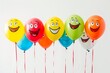© Yuliia - Colorful balloons with smiling faces in a row on white background